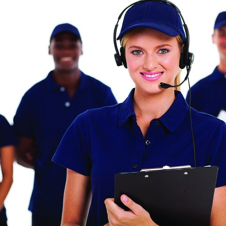IT service call center operator with headphones and team